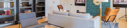 a living room with couches chairs and a bookshelf