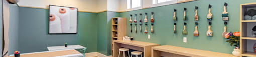 a room with tables and stools and squash rack on the wall