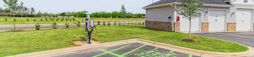 a parking lot with a message painted on it in front of a house