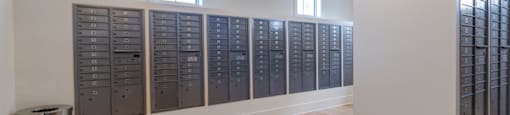 a large room with lockers and a trash can