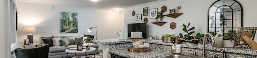 A kitchen with a black dishwasher and a black chair.