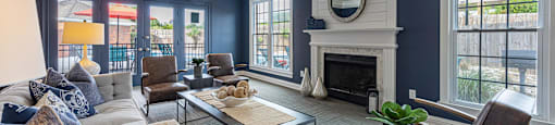 a living room with blue walls and a white fireplace
