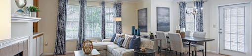 a living room and dining room with a couch and a table