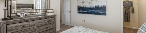 a bedroom with a bed and a dresser and a mirror