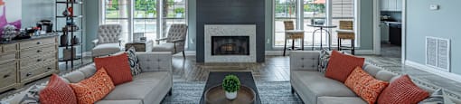 a large living room with couches and a fireplace
