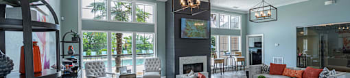 a living room with couches and chairs and a fireplace