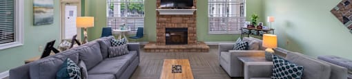 a large living room with couches and a fireplace