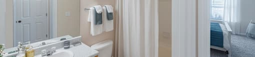 a bathroom with a shower and a sink and a toilet
