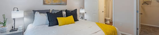 a bedroom with a large bed and a ceiling fan