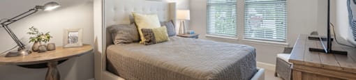 a bedroom with a bed and a ceiling fan