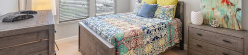 a bedroom with a bed and a ceiling fan