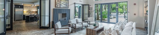a living room with a couch and chairs and a fireplace