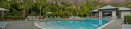 a swimming pool at a resort with chairs