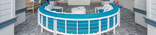 a clubhouse with a large blue pool and a television