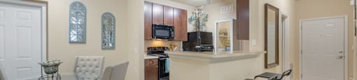an open kitchen and dining area with a glass table and chairs