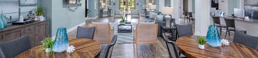 a dining room with tables and chairs and a living room