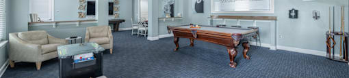 a game room with a pool table and a bar