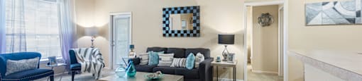 a living room with furniture and a ceiling fan