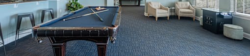 a large game room with a pool table