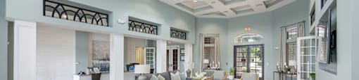 a large living room with chairs and couches