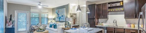 a kitchen and living room with wood flooring and