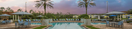 a pool with chairs and umbrellas at a resort
