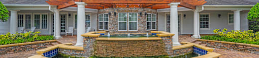 a fountain in front of a house