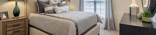 a bedroom with a large bed and a window