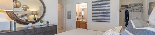a bedroom with a bed and a mirror and a closet