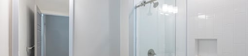 a bathroom with a shower and a sink and a toilet