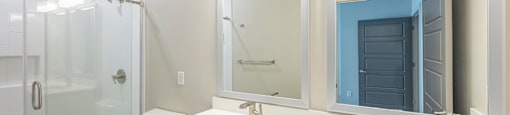 A bathroom with a toilet, sink, and mirror.