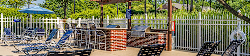 a patio with chairs and tables and a gazebo