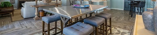 a living room with a dining room table and chairs