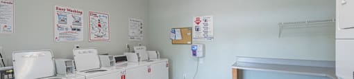 the laundry room is equipped with washes and dryers and a counter with a
