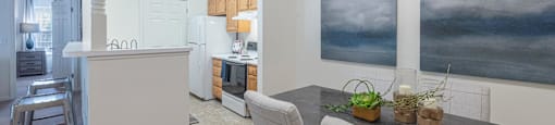 a kitchen and dining room with a table and chairs
