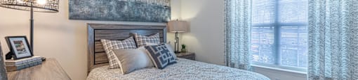 a bedroom with a bed and a large window