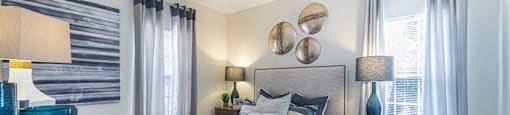 a bedroom with a large bed and a window