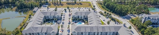 an aerial view of a resort with buildings and a pool