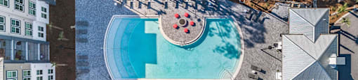 an aerial view of a pool at a hotel with a swimming pool