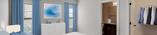 A bedroom with a white bed and blue curtains.