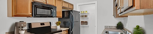 A kitchen with wooden cabinets and a granite countertop.