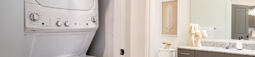 Altitude Raleigh model bedroom with full size washer and dryer
