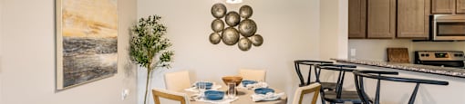 a dining room with a table and chairs and a kitchen