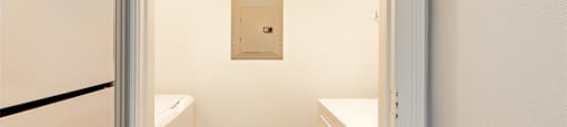 a kitchen with a refrigerator and a sink and a door
