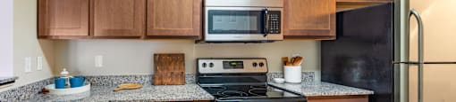 a kitchen with stainless steel appliances and granite counter tops