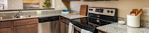 a kitchen with stainless steel appliances and granite counter tops