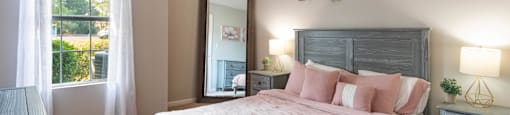 a bedroom with a large bed and a large window
