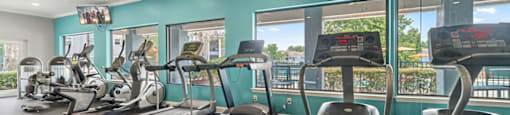 A gym with treadmills and exercise bikes.