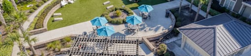 an aerial view of the courtyard of an apartment building with tables and chairs