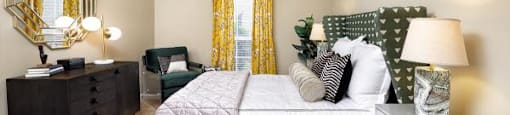 A bedroom with a bed, dresser, and mirror.